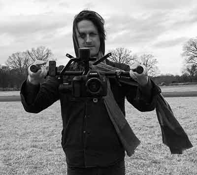 chris wilson in jacket holding camera