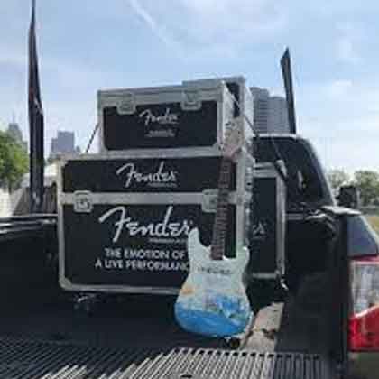 fender guitar and road cases in the back of a Nissan Titan