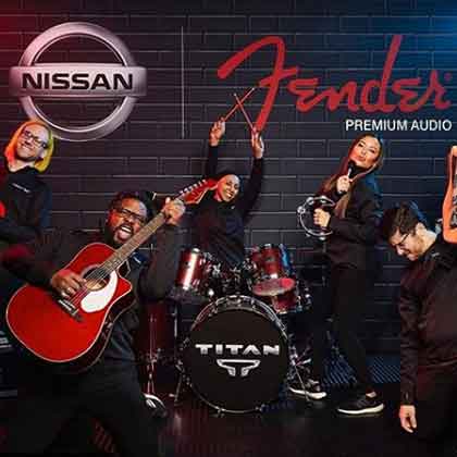 Event attendees pretend to play instruments on Fender branded stage